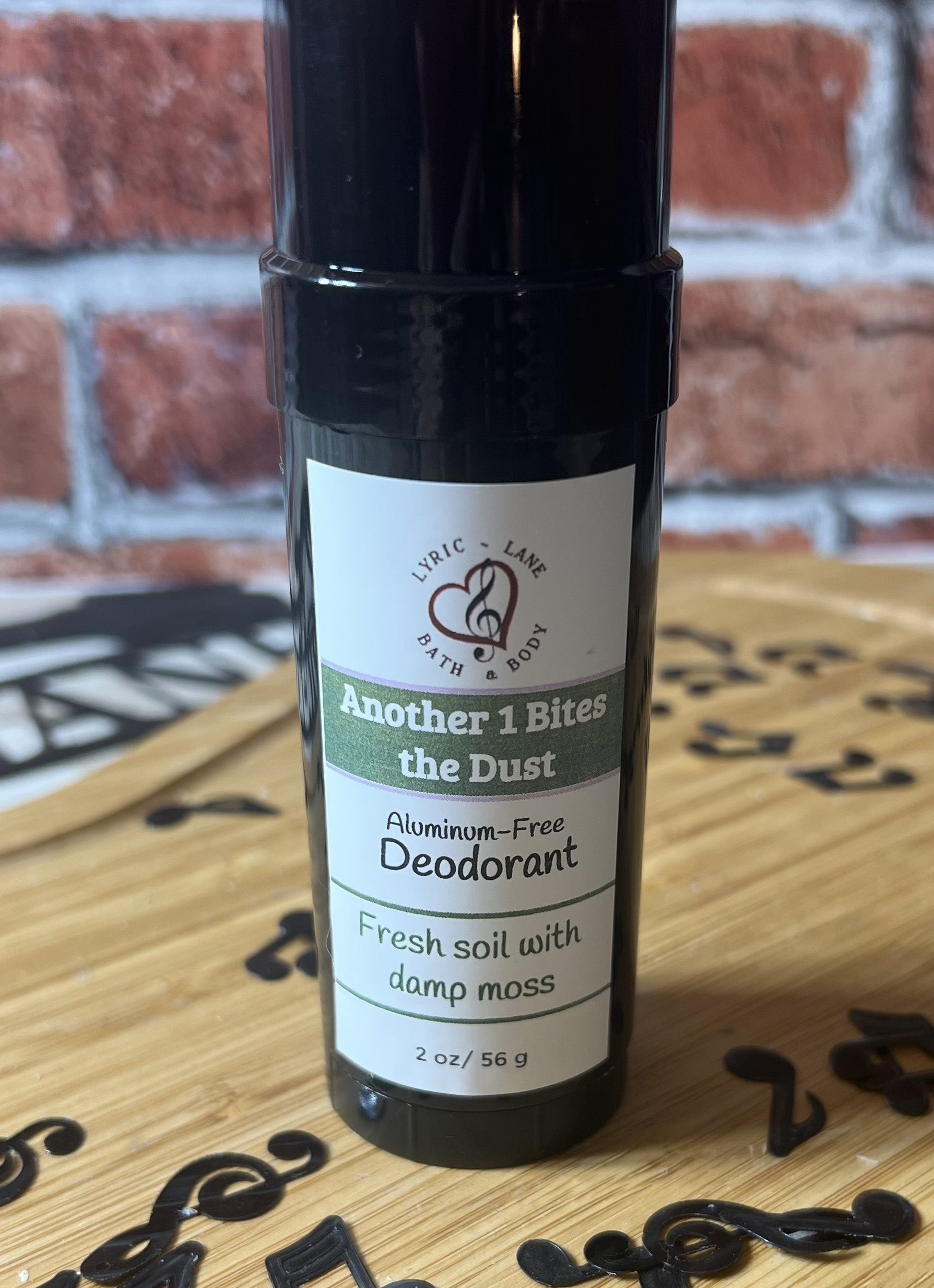 Lyric-Lane aluminum-free deodorant with fresh soil and damp moss scent, Another 1 Bites the Dust - Smells Like Dirt. On Purpose.