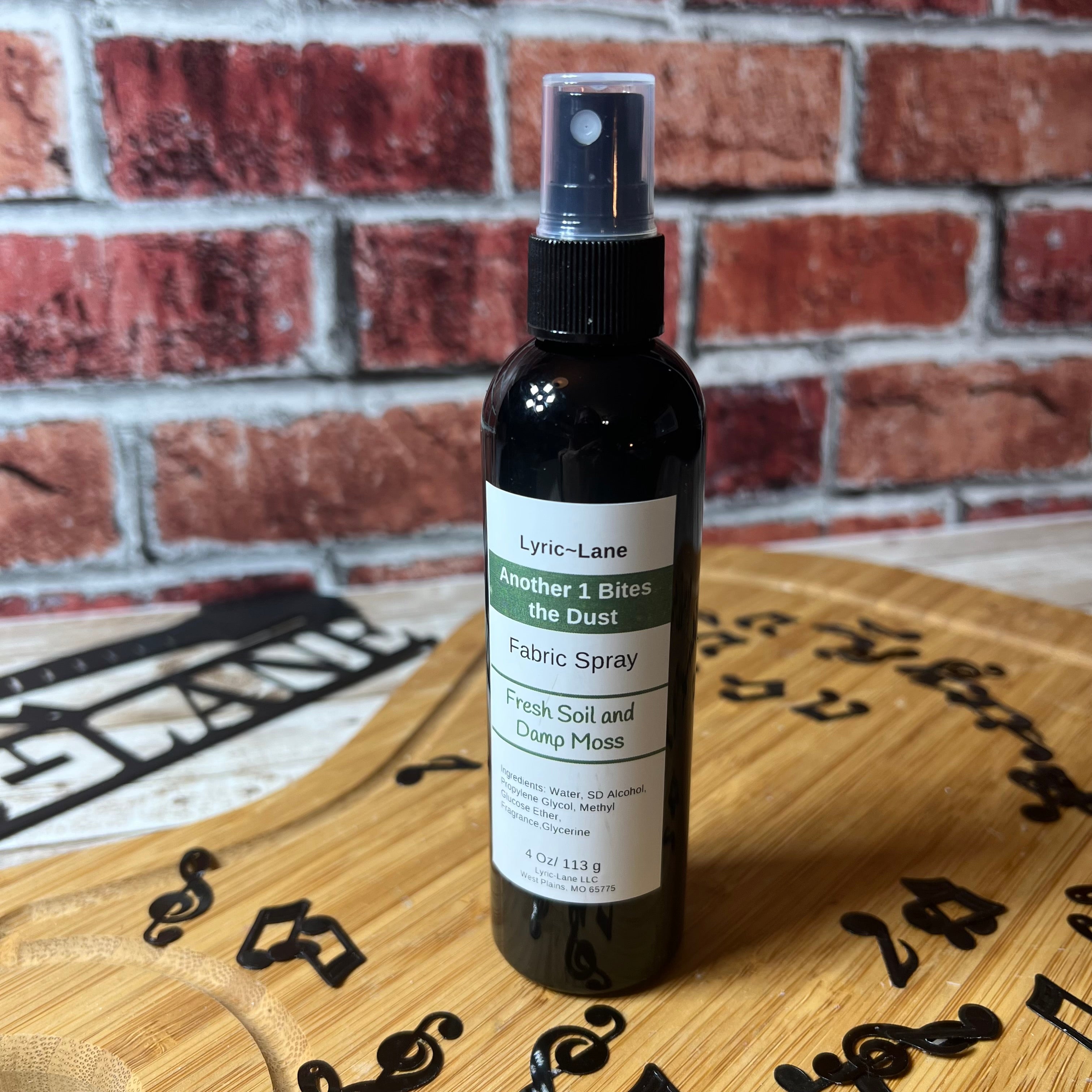 Lyric-Lane fabric spray featuring Another 1 Bites the Dust - Smells Like Dirt. On Purpose. with fresh soil and damp moss scent