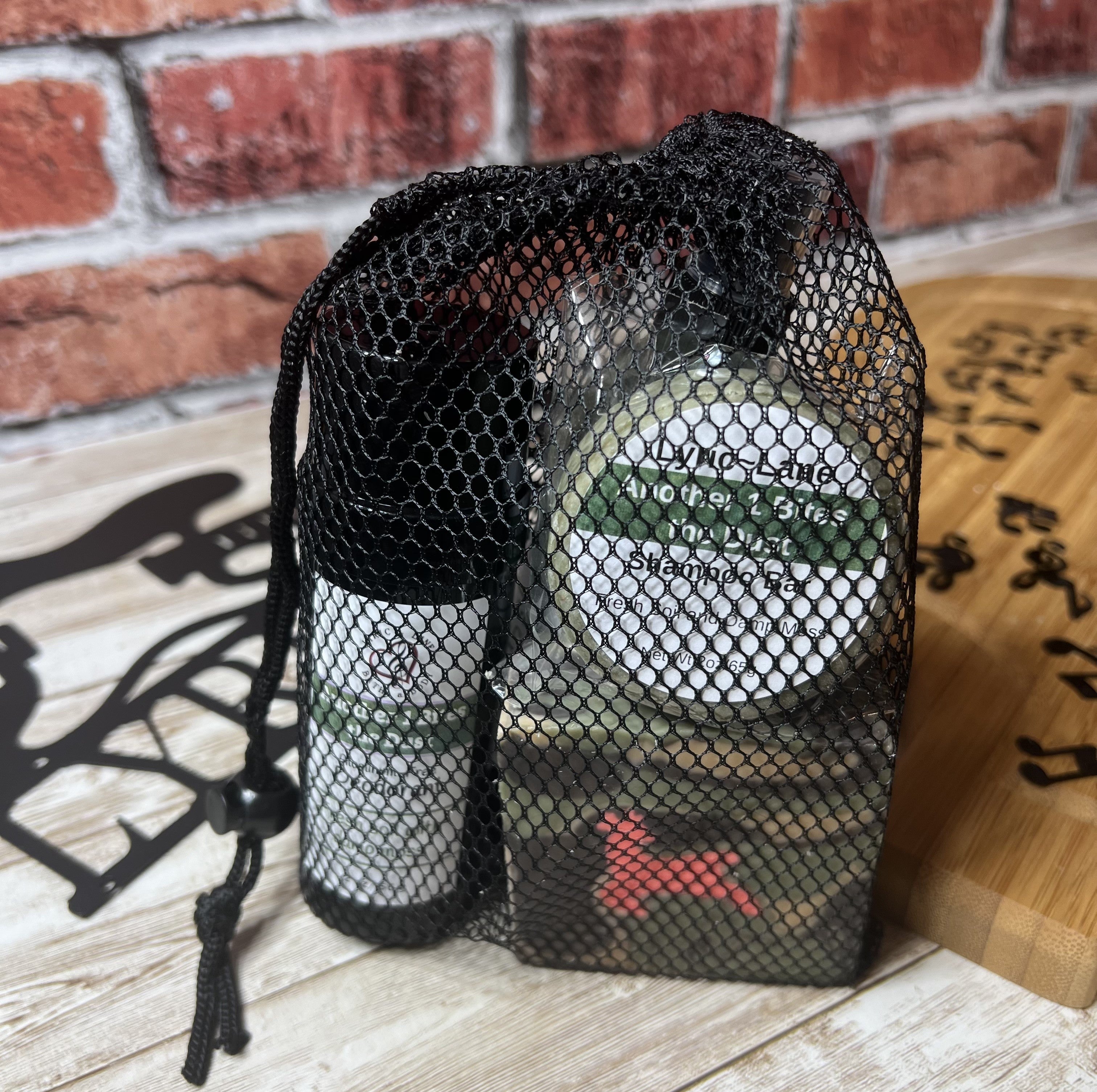 Lyric-Lane bath and body set in black mesh bag featuring Another 1 Bites the Dust - Smells Like Dirt. On Purpose. products