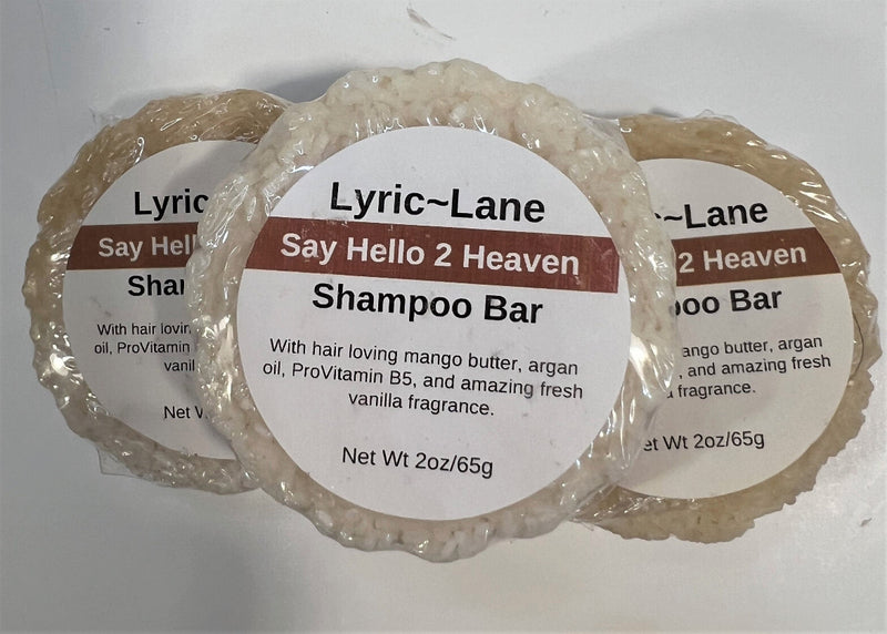 Three 2oz round bars of Say Hello 2 Heaven Shampoo Bars. Cream colored bars scented with vanilla fragrance stacked in a pyramid on a white background. Made by Lyric-Lane