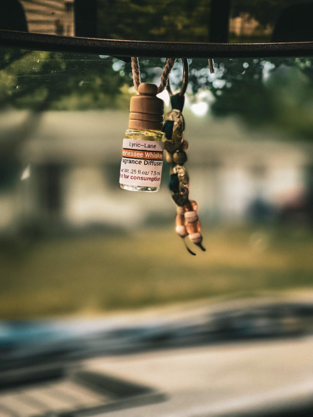 Tennessee Whiskey glass diffuser bottle hanging from car rear view mirror