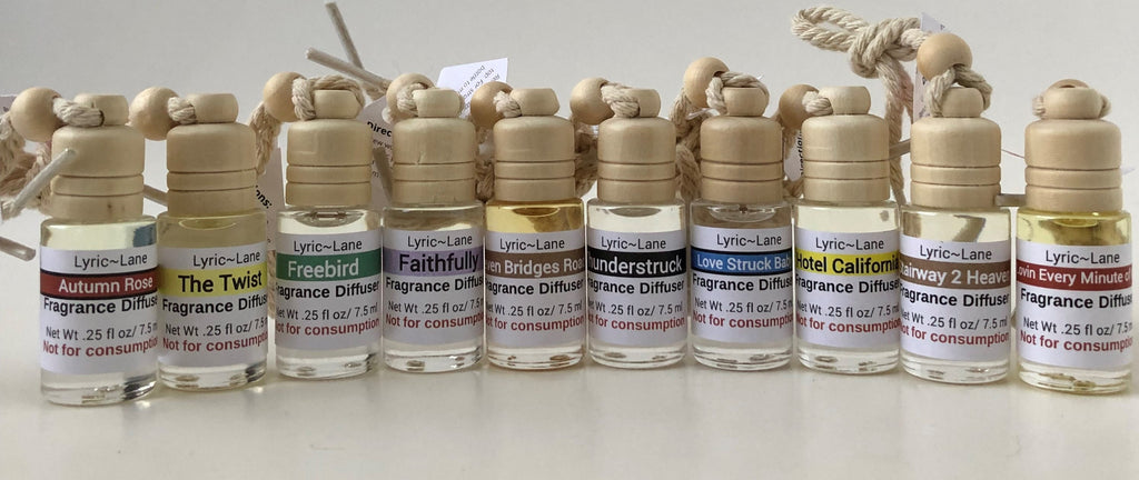 A close up of an aromatherapy diffuser filled with Thunderstruck fragrance on a wooden board with scattered music notes. Made by Lyric Lane Soap.