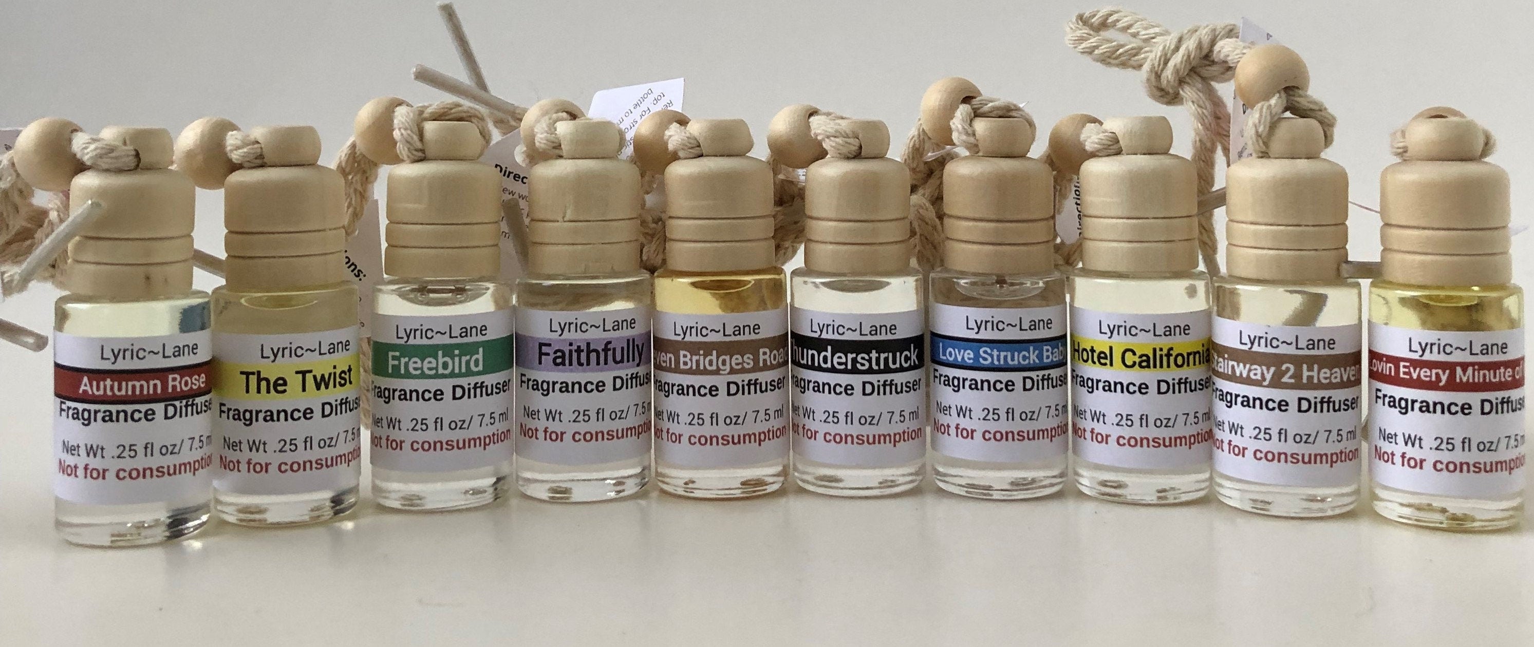 A close up of an aromatherapy diffuser filled with Thunderstruck fragrance on a wooden board with scattered music notes. Made by Lyric Lane Soap.